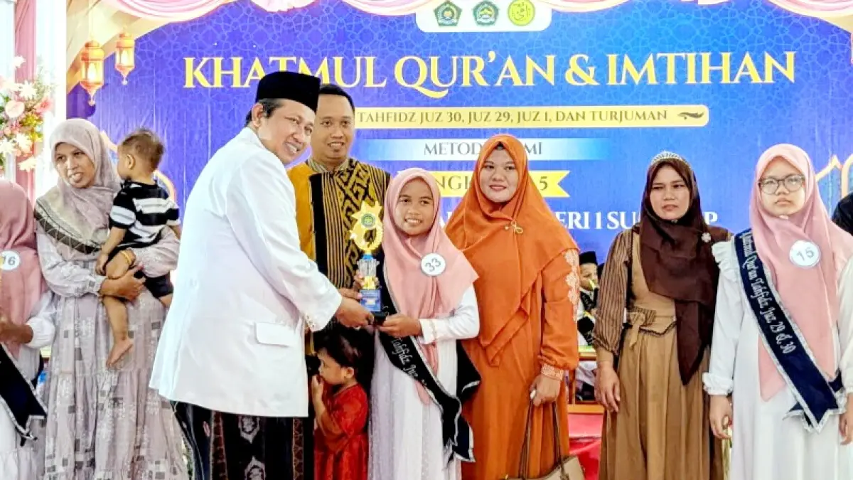 KOMPAK: Kepala MIN 1 Sumenep Tri Wahyudi Januarianto memberikan penghargaan kepada siswa berprestasi dalam kegiatan Khatmul Qur