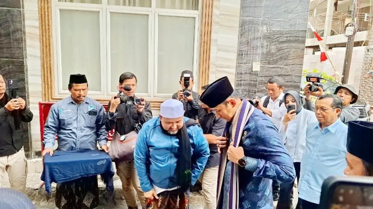TAMU KEHORMATAN: Pengasuh Ponpes Nurul Cholil KH Abdullah Zuber menyambut kedatangan Menko Bidang Infrastruktur dan Pembangunan Kewilayahan Agus Harimurti Yudhoyono di pesantren, Minggu (2/8). (MUSTAFA UNTUK JPRM)
