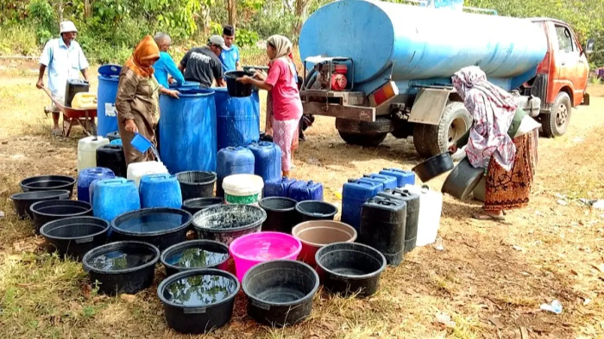TERDAMPAK KEKERINGAN: Warga Desa Gunilep, Kecamatan Sepulu, mengantre air bersih, Senin (27/7). (BPBD UNTUK JPRM)