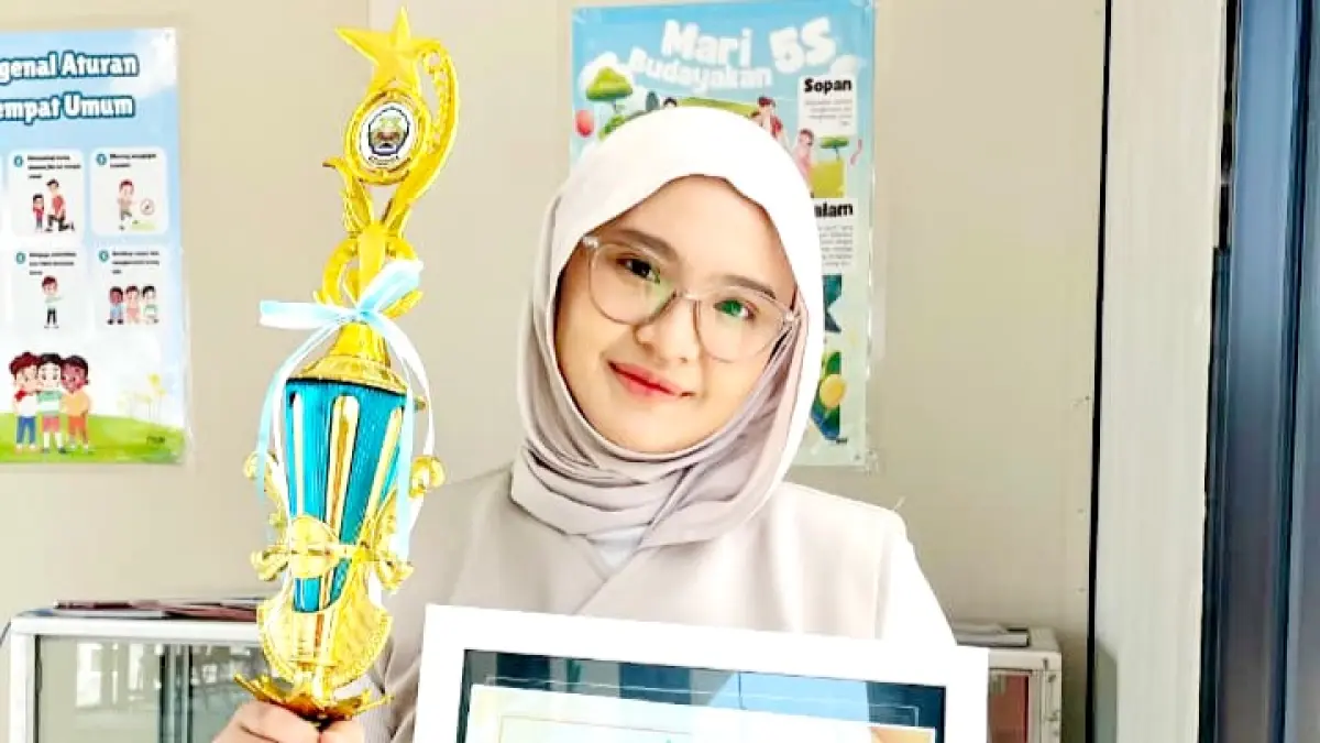 PENUH TALENTA:&nbsp; Zhafira Zila Qonita menerima piala dan piagam penghargaan Juara I Lomba Video Konten Literasi Dispusip Bangkalan, Jumat (14/8). (ZHAFIRA ZILA QONITA UNTUK JPRM)