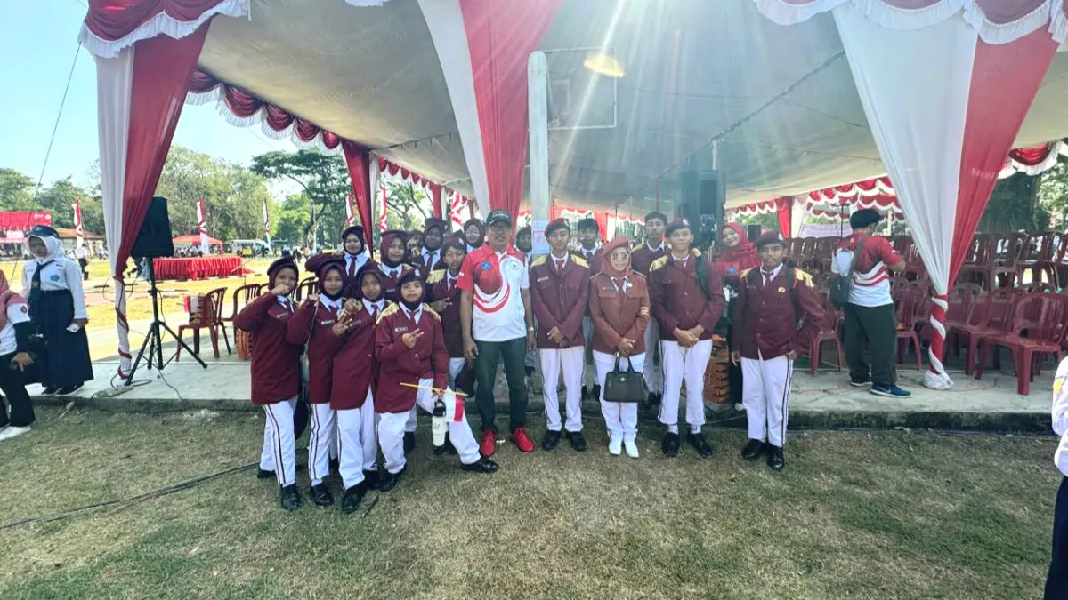 TUMBUHKAN NASIONALISME: Ketua MKKS SMP Negeri Bangkalan Hermanto berfoto bersama pelajar usai menampilkan aubade kebangsaan pasca upacara peringatan HUT Ke-81 RI di alun-alun, Senin (17/8). (MKKS SMP NEGERI UNTUK JPRM)