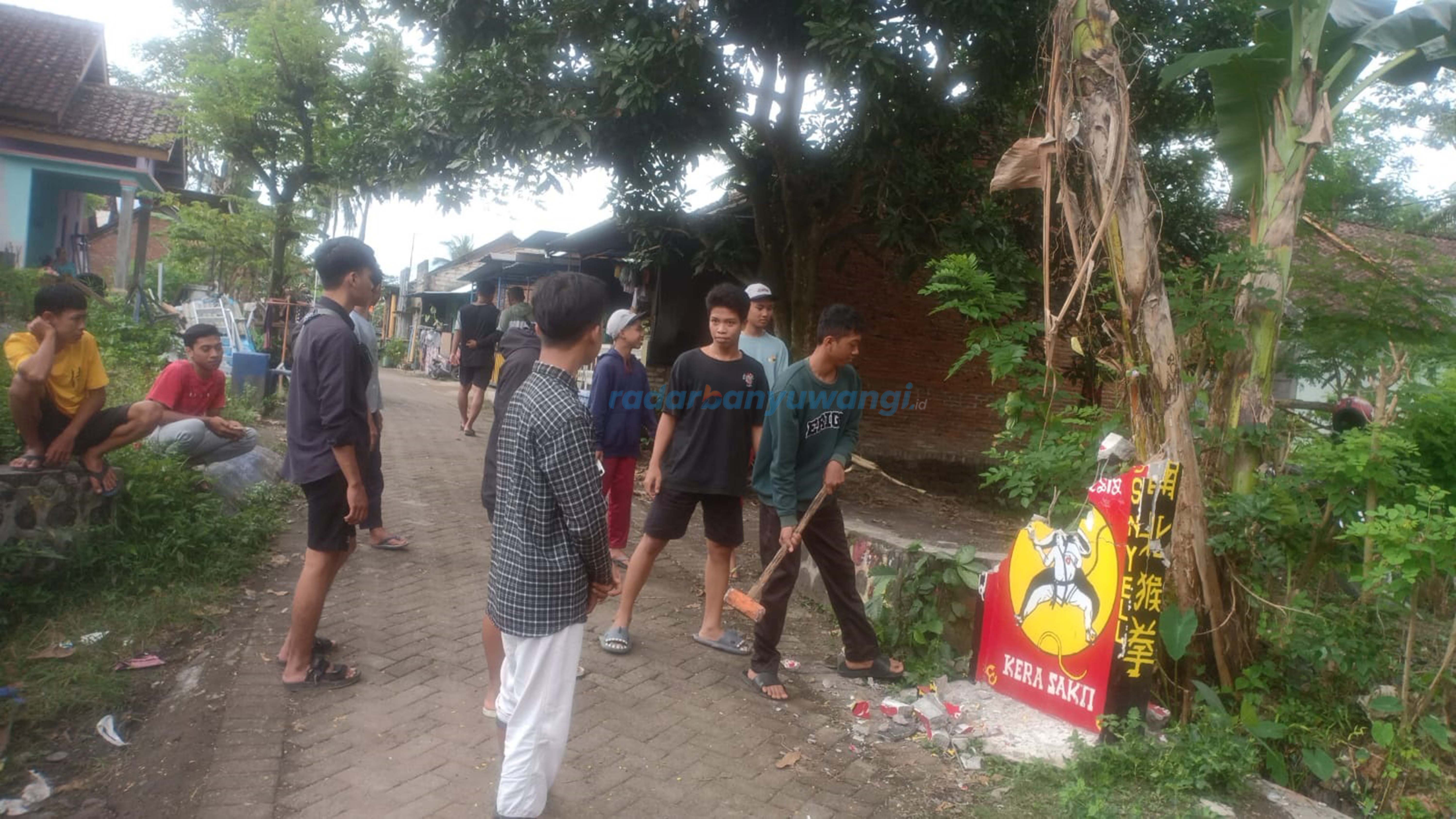 DIHANCURKAN SENDIRI: Sejumlah anggota perguruan Kera Sakti membongkar tugu perguruan silat di Kecamatan Kalipuro