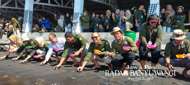 PENUTUPAN KKN: Rektor Uniba Dr H Sadi MM dan sejumlah dosen melepas tukik di Pantai Gumuk Kantong, Desa Sumbersewu, Kecamatan Muncar, Rabu (2/8).