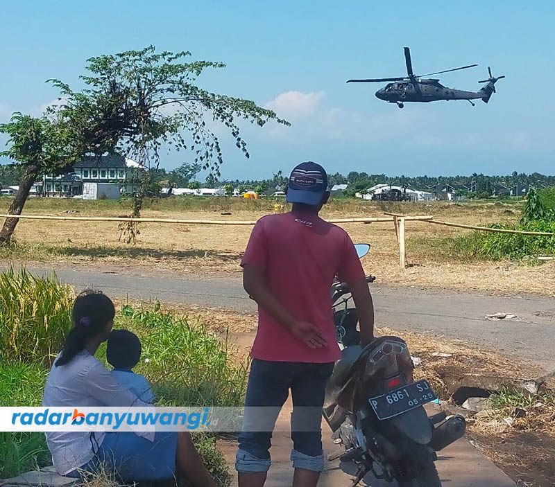 PEMANDANGAN LANGKA: Warga menyaksikan helikopter yang sedang landing di lapangan Satuan Yonif Raider 515 Kostrad di Desa Pakistaji, Kecamatan Kabat, Selasa (29/8).
