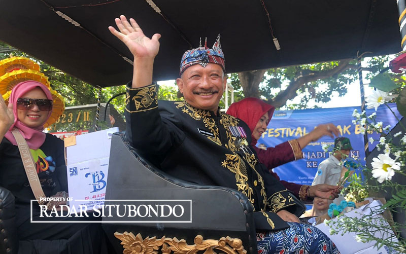 FULL SENYUM: Bupati Situbondo, Drs. Karna Suswandi  mengendarai kereta setelah membuka peringatan Hari Jadi Besuki ke-259, di Desa/Kecamatan Besuki, Rabu (13/9).