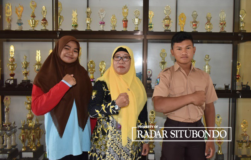 PERAIH JUARA: Kepala SMA Negeri 1 Kapongan, Dwi Retno Susanti, S.Pd, MMPd diapit dua murid berprestasi.