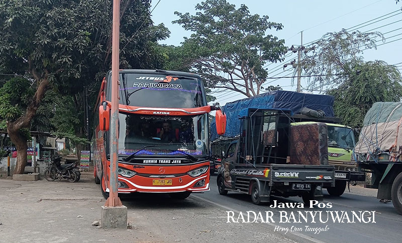 NGEBLONG: Bus pariwisata bernopol K 7383 BD nekat menerobos jalan hingga memicu kemacetan panjang di jalan raya Wongsorejo, Jumat (10/11).