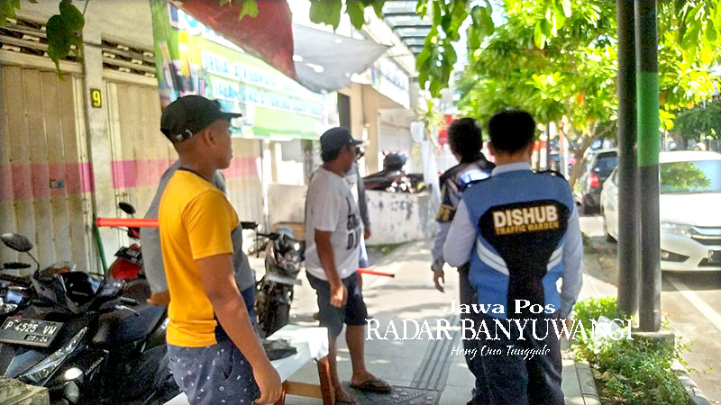 DITERTIBKAN: Petugas Dishub Banyuwangi menertibkan jukir liar di Jalan Ahmad Yani, Rabu (27/12).