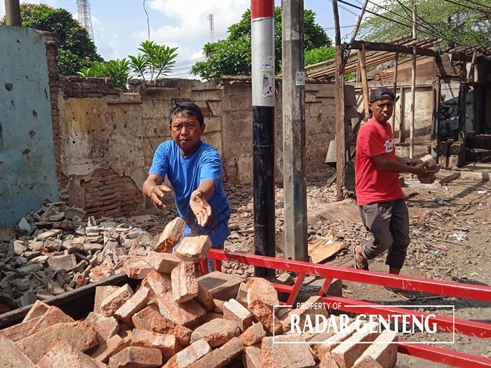 EKSEKUSI: Pedagang pasar loak di Jalan Hasanuddin, Dusun Krajan, Desa Genteng Wetan, Kecamatan Genteng mulai mengosongkan kiosnyak Selasa (2/1).