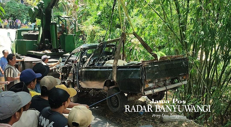 DIANGKAT DARI JURANG: Pikap bernopol P 8160 VE yang terjun ke jurang di Desa Jambesari, Giri, Banyuwangi, pada Rabu malam (3/1) dievakuasi menggunakan crane Kamis (4/1).