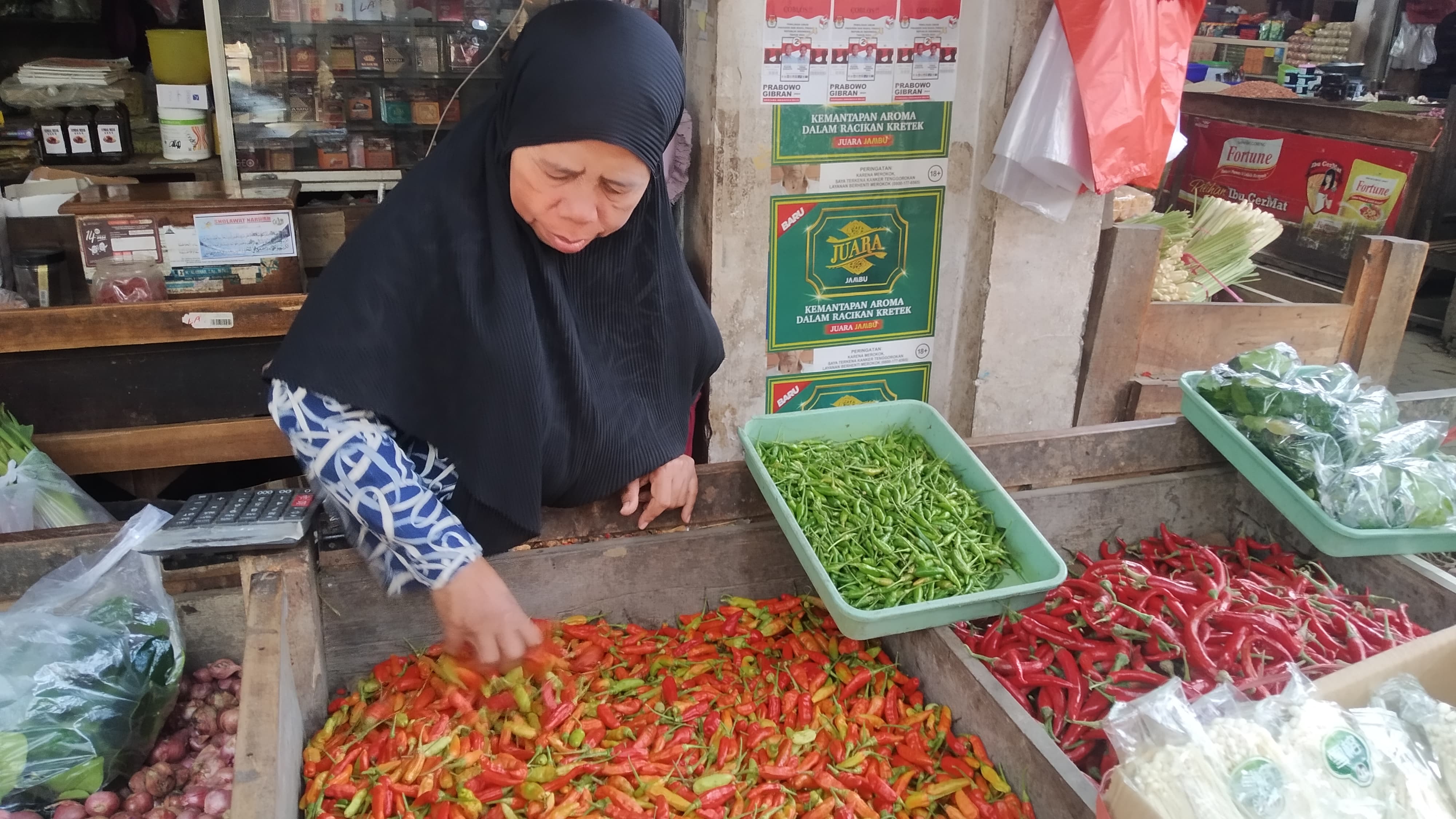 HARGA NAIK: Pedagang cabai di Pasar Induk Genteng 1, Desa Genteng Kulon, Kecamatan Genteng merapikan dagangannya sambil menunggu pembeli Minggu (18/2).