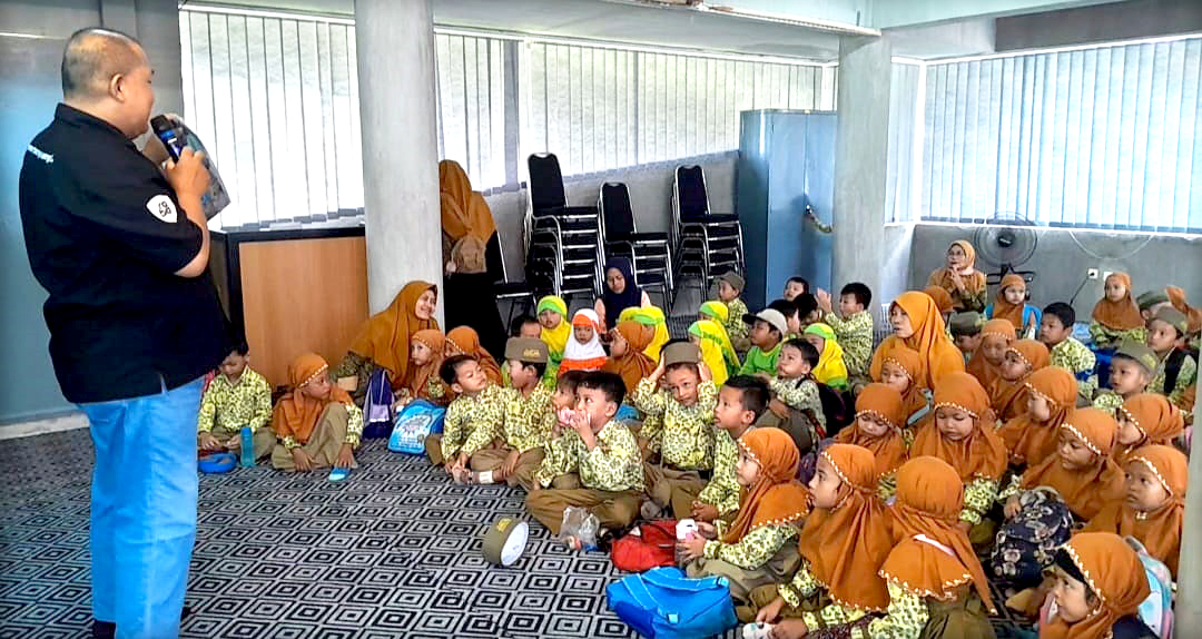 BIG GUIDE : Kru JP-RaBa Beny Siswanto memandu puluhan murid TK Bustanul Athfal saat berkunjung ke Gedung Grha Pena Banyuwangi Jumat (23/2).