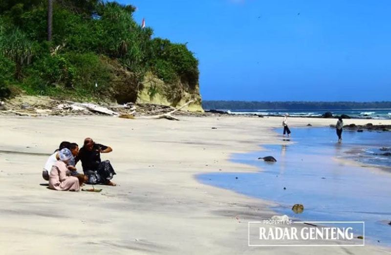 Wisatawan menikmati suasana di hamparan pasir putih di Pantai Pancur, Taman Nasional Alas Purwo.