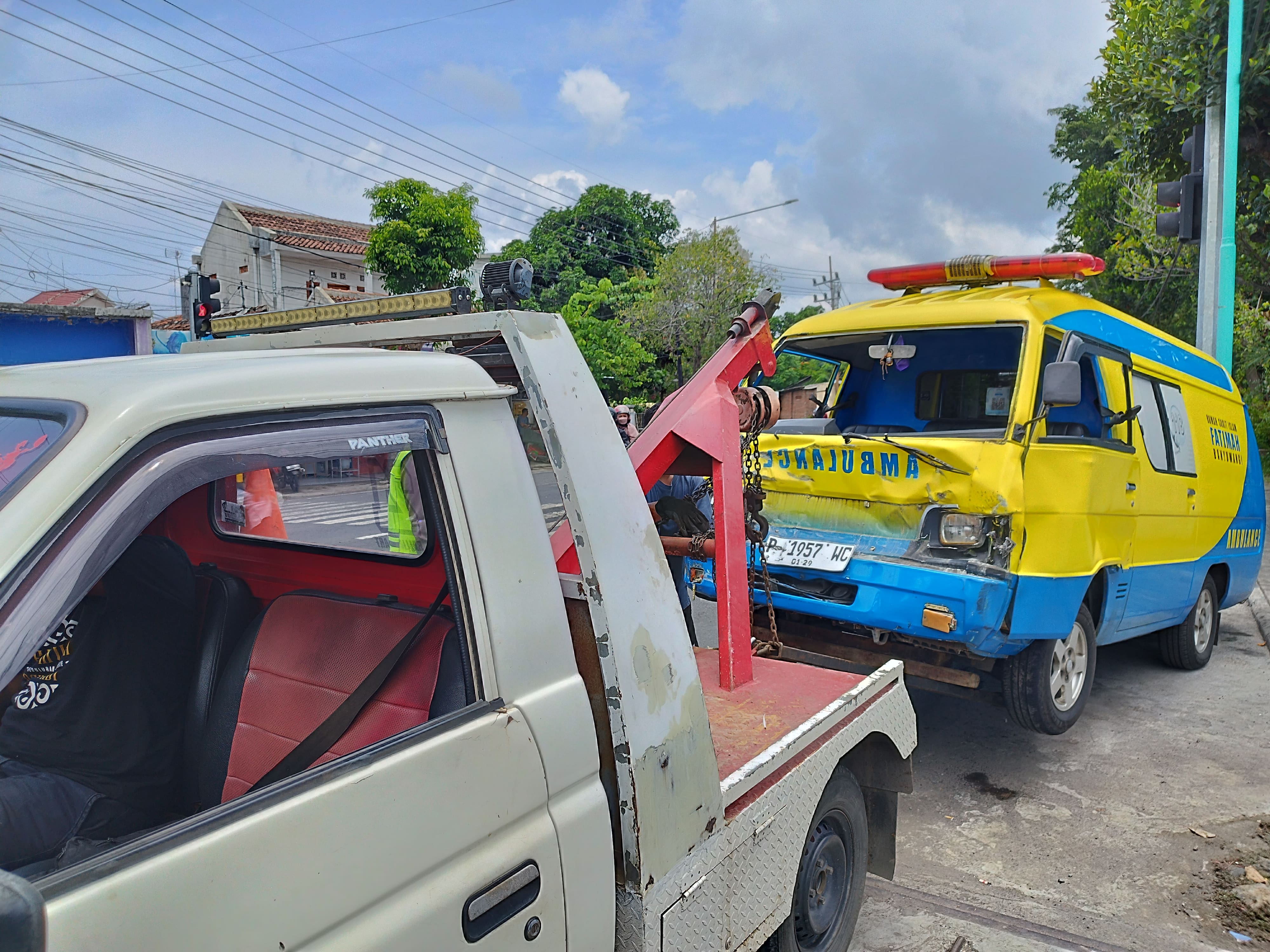 DIDEREK: Mobil ambulans milik RS Fatimah yang ringsek di bagian depan dievakuasi ke Mako Satlantas Polresta Banyuwangi pada Senin (26/2).