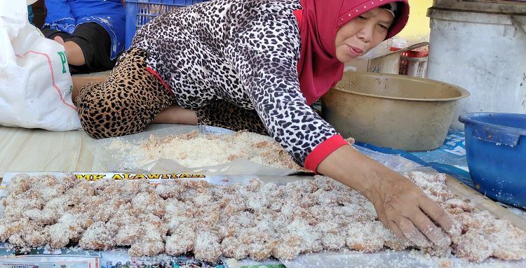 TERSEDIA: Warga menata manisan buah pala pada papan sebelum dijemur di tempat terbuka.