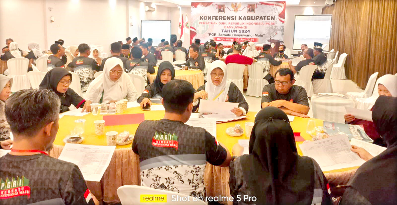 RAPAT: Peserta konferensi PGRI tampak serius dalam rapat komisi di Hotel Baru Indah, Desa Jajag, Kecamatan Gambiran pada Sabtu (1/6).