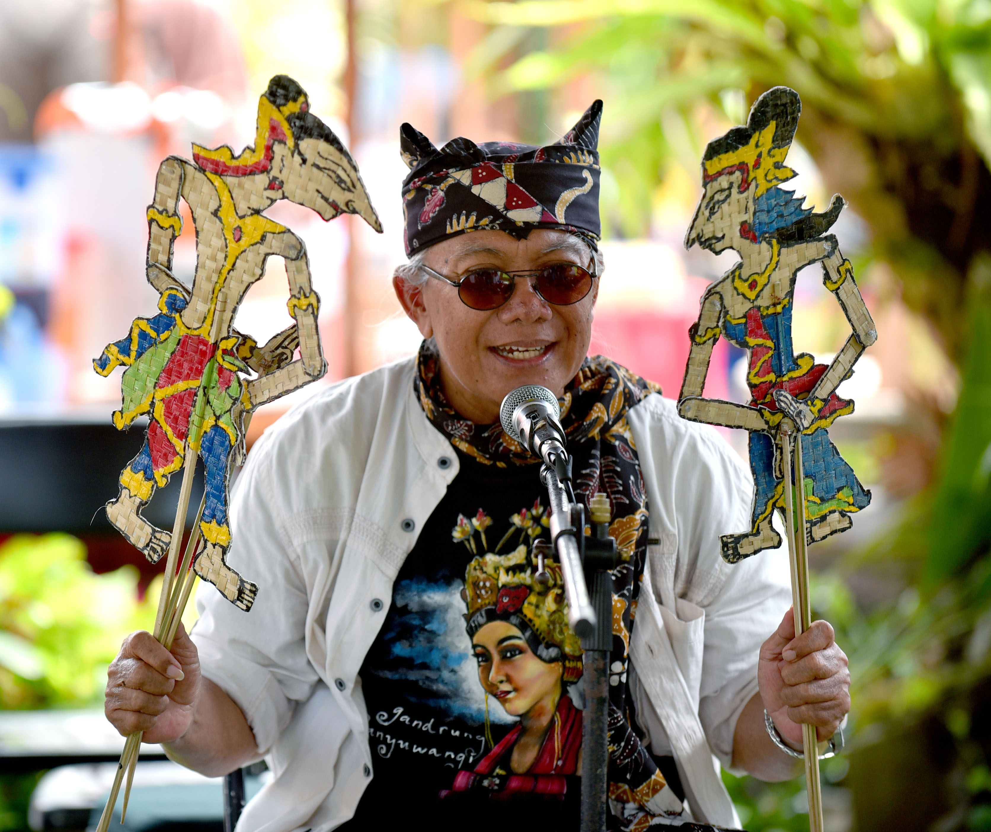 MENGHIBUR: Budayawan senior Banyuwangi, Aekanu Hariyono, bercerita sejarah Bumi Blambangan di hadapan anak-anak sekolah memakai alat peraga wayang kulit.&nbsp;