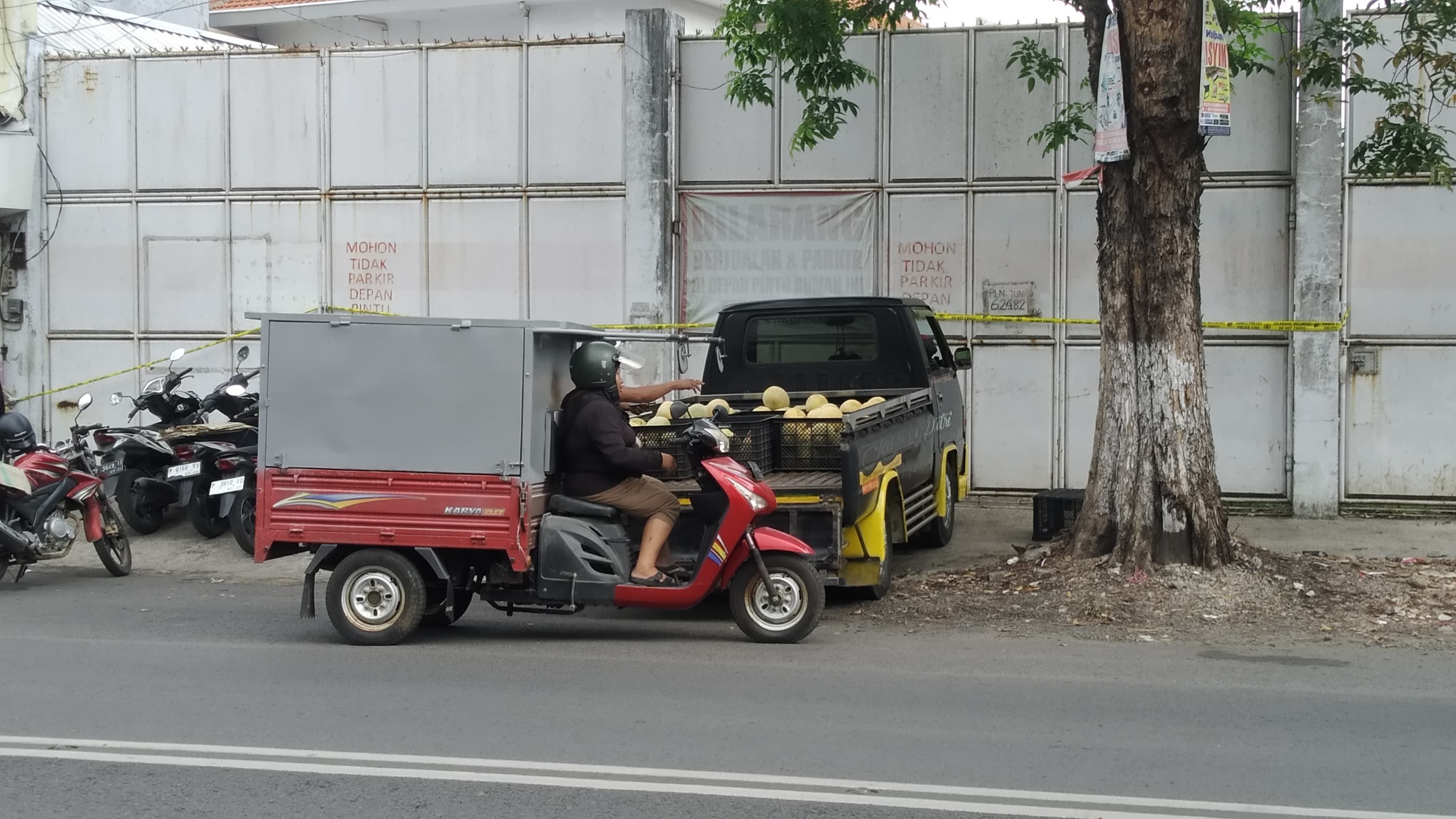 TERTUTUP: Pintu gerbang rumah yang digerebek Bareskrim Mabes Polri di Jalan Gajah Mada, Dusun Sawahan, Desa Genteng Kulon, masih dipasang garis polisi hingga Jumat (28/6).