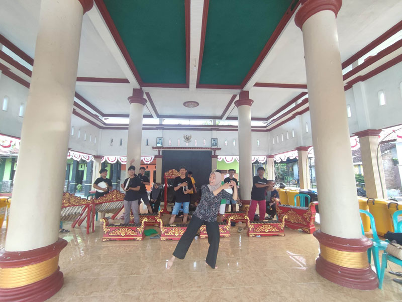 PERTUNJUKAN: Miftahul Jannah memberikan arahan koreografi saat melatih para pemuda di Kantor Desa Aliyan, Kecamatan Rogojampi Kamis (11/7)