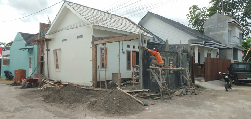 BELUM RAMPUNG: Pekerja membangun rumah di salah satu perumahan di Banyuwangi Rabu (7/8).