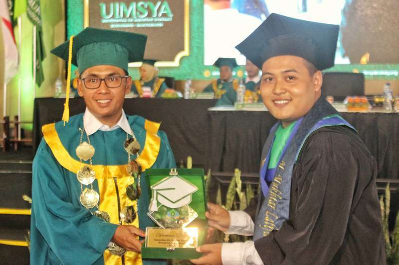 PRESTASI: Rektor  Dr KH Ahmad Munib Syafaat LC MEI (kiri) memberikan cenderamata sebagai penanda wisudawan terbaik kepada Muhammad Mukhtar Latifil Ansori pada Senin (14/10).
