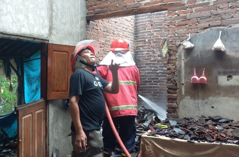 HANGUS: Susiono (kiri) melihat bangunan rumahnya yang hangus terbakar Selasa (15/10).