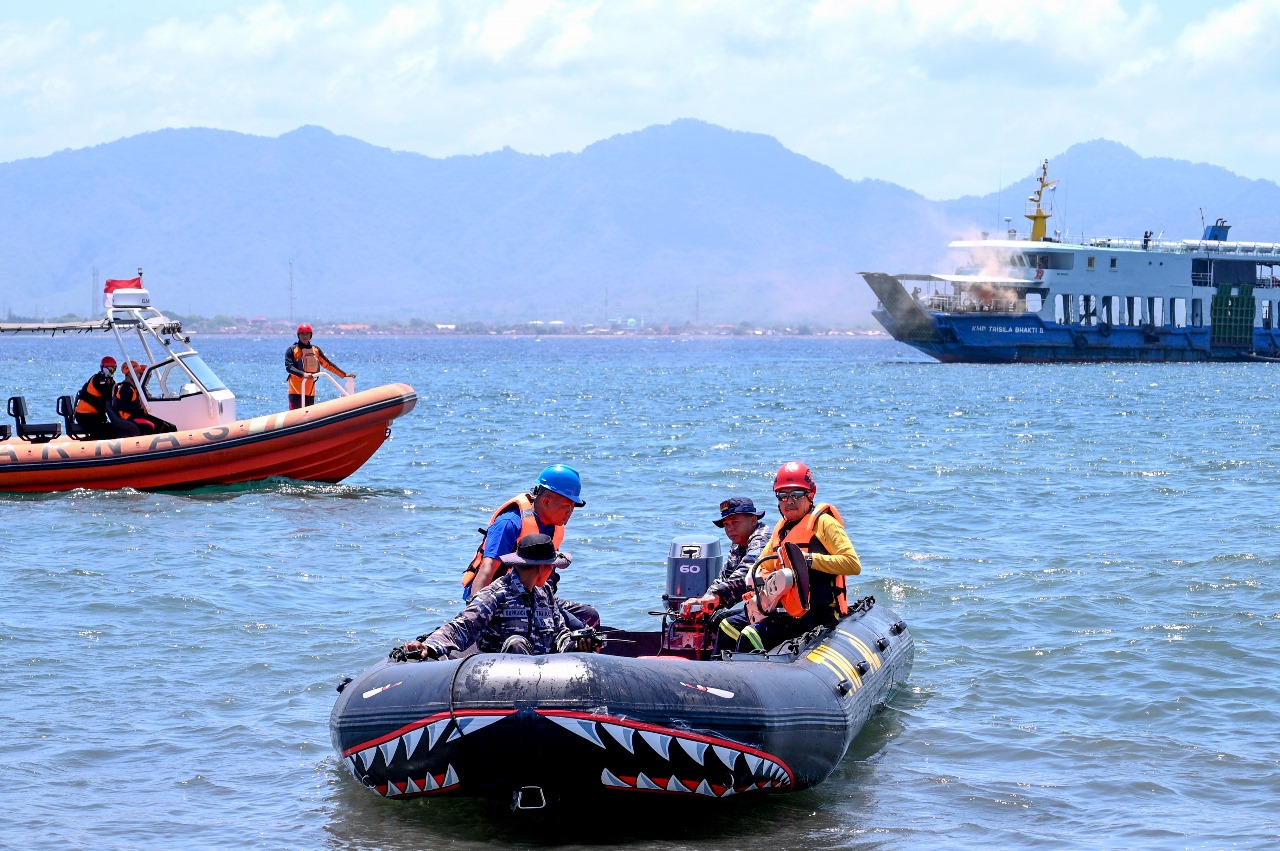 Dua Petugas PLN dengan alat pemotong dengan dibantu petugas dari TNI-AL dan Basarna menuju Kapal Trisila Yang jangkarnya terkait Kabel Bawah laut 150KV Jawa-Bali di Pantai Bulusan Banyuwangi.