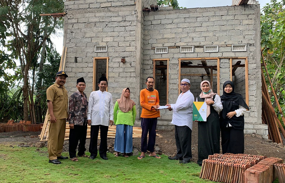 KEMANUSIAAN: Pengurus Baznas dan UPZ menyerahkan bantuan biaya rehab rumah kepada Nurul Huda.