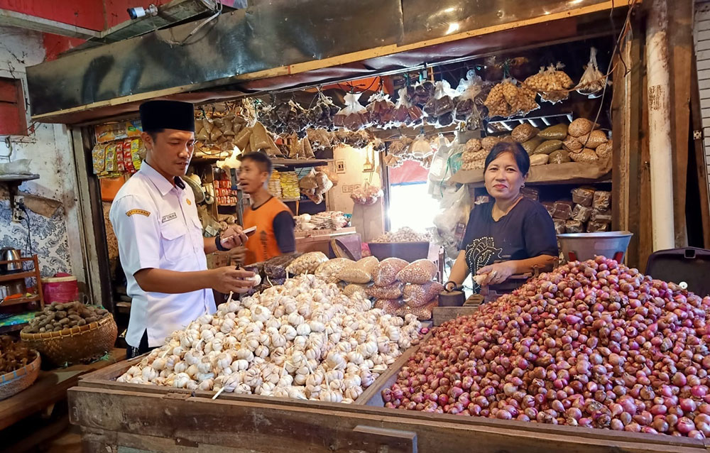 Petugas Pasar Induk Genteng 1, Desa Genteng Kulon, Kecamatan Genteng mengecek harga bahan dapur di pedagang Jumat (29/11).