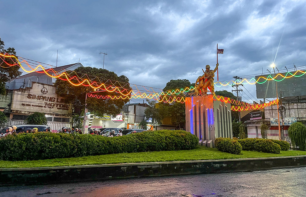 Lampu penuh warna-warni menghiasi patung perjuangan yang terpasang di Simpang Lima Banyuwangi.