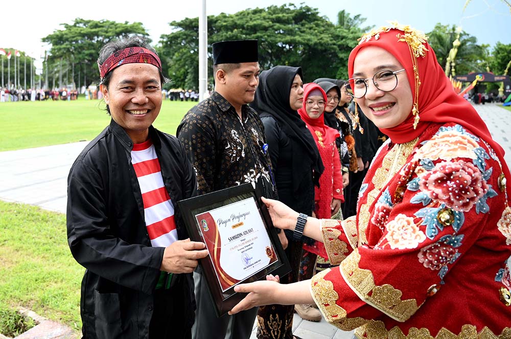 Bupati Ipuk Fiestiandani menyerahkan sertifikat penghargaan pencipta tagline Sunrise of Java kepada Samsudin Adlawi, 18 Desember lalu.