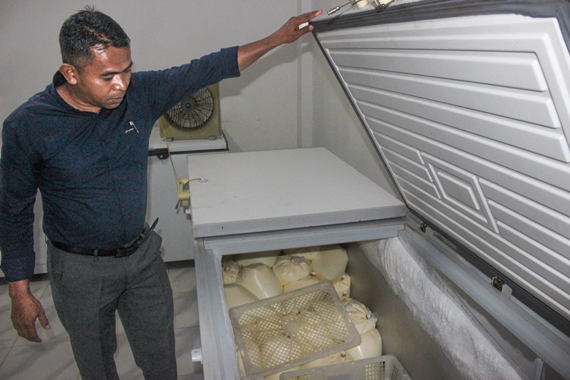 KUALITAS: Manajer peternakan Dairy Farm Margo Utomo, Sugeng Hariyanto menunjukkan susu segar yang disimpan di lemari pendingin peternakannya.