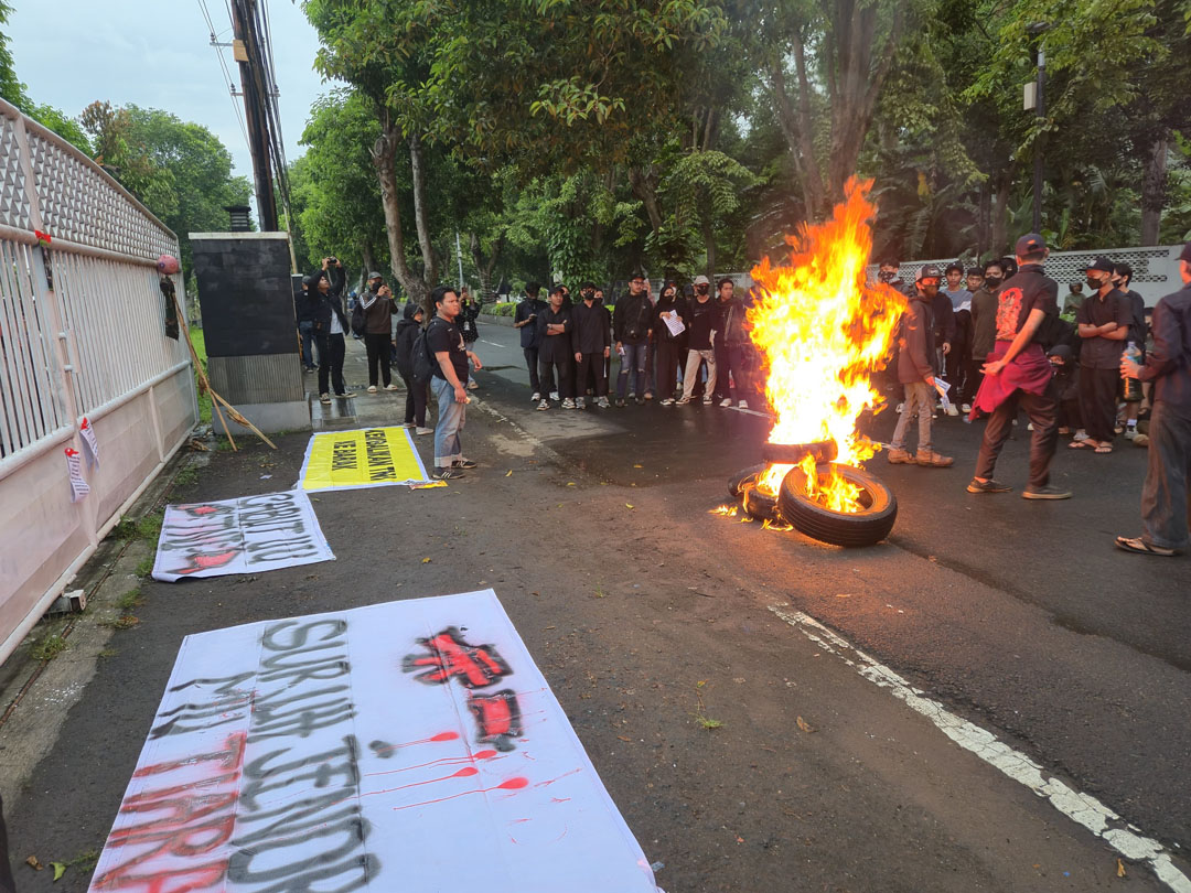 MEMBARA: Aksi demo mahasiswa menolak revisi UU TNI di depan kantor DPRD Banyuwangi diwarnai dengan pembakaran ban bekas.