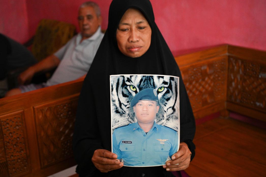 TUNJUKKAN FOTO RIZAL: Keluarga Rizal Sampurna di Sukowidi Banyuwangi menunggu kedatangan jenazah PMI yang meninggal di Kamboja tersebut.