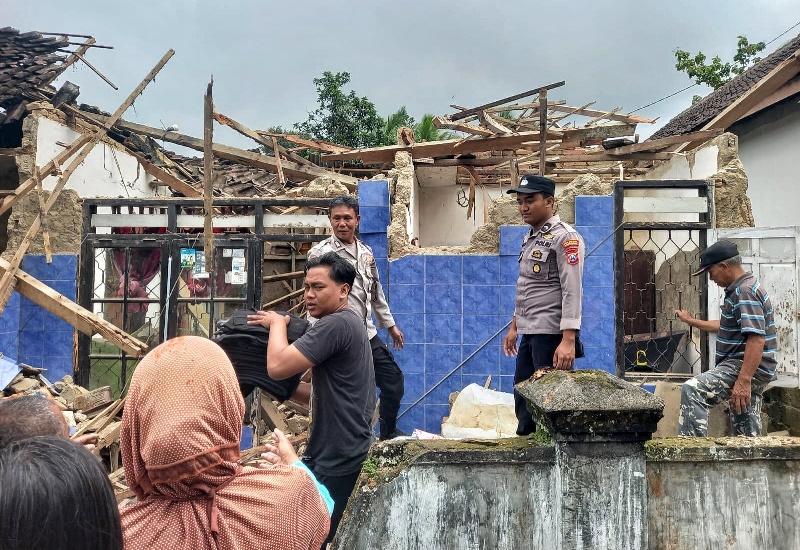 LULUH LANTAH: Warga dan anggota polisi kerja bakti membersihkan rumah milik Sri Rezeki di Dusun Sumberasri, Desa/Kecamatan Songgon yang ambruk Rabu (7/5).