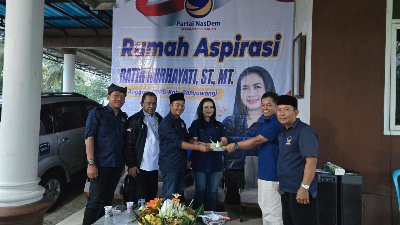 Ketua DPD NasDem Banyuwangi Ali Mustofa menyerahkan potongan tumpeng kepada Ketua Bamag Sempu Gideon Sunoto disaksikan Sekretaris Pebdi Arisdiawan, Bendahara Teddy Anugrianto, dan Ketua Fraksi NasDem