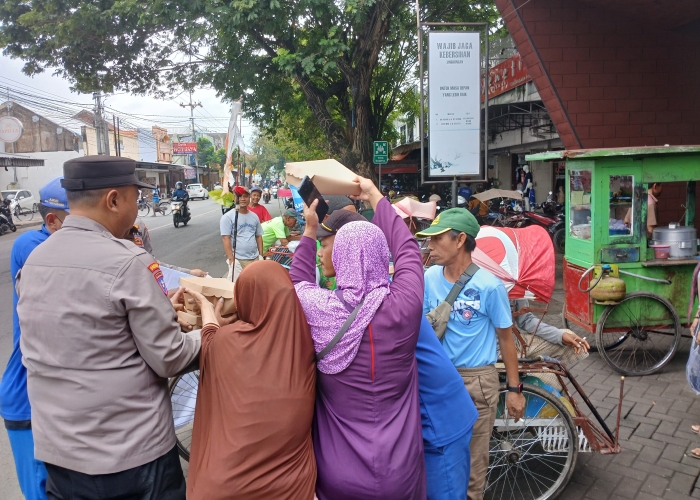 Polresta Banyuwangi gelar program Jumat Berkah, bagikan nasi kotak ke tukang becak dan ojek online sebagai bentuk kepedulian nyata.