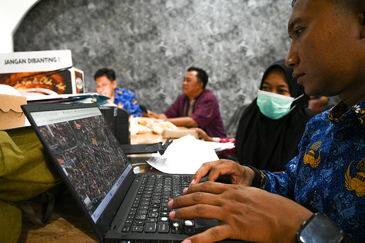 BERBASIS INTERNET: Orang tua murid memastikan titik lokasi tempat tinggal serta jarak dengan sekolah tujuan di kantor Dispendik Banyuwangi beberapa hari lalu (2/6).