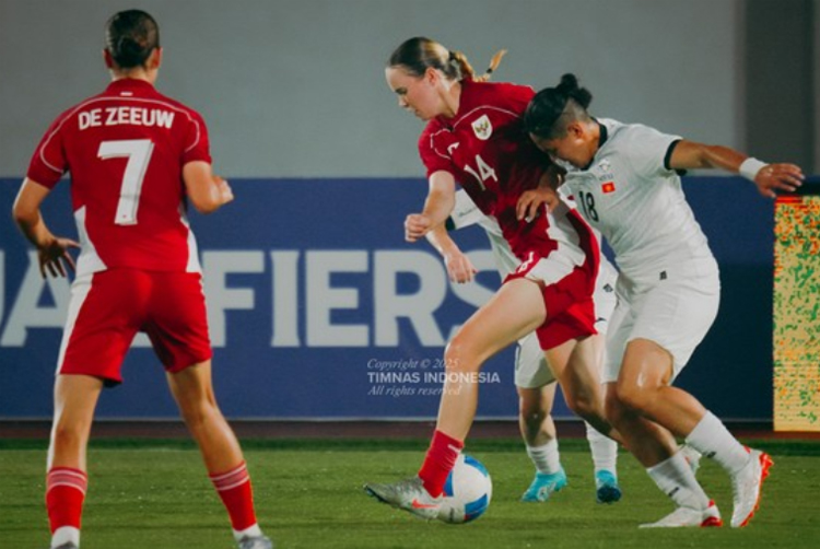 Pemain Timnas Putri Indonesia Isa Warps berebut bola dengan pemain Kirgistan. Dia mencetak gol.