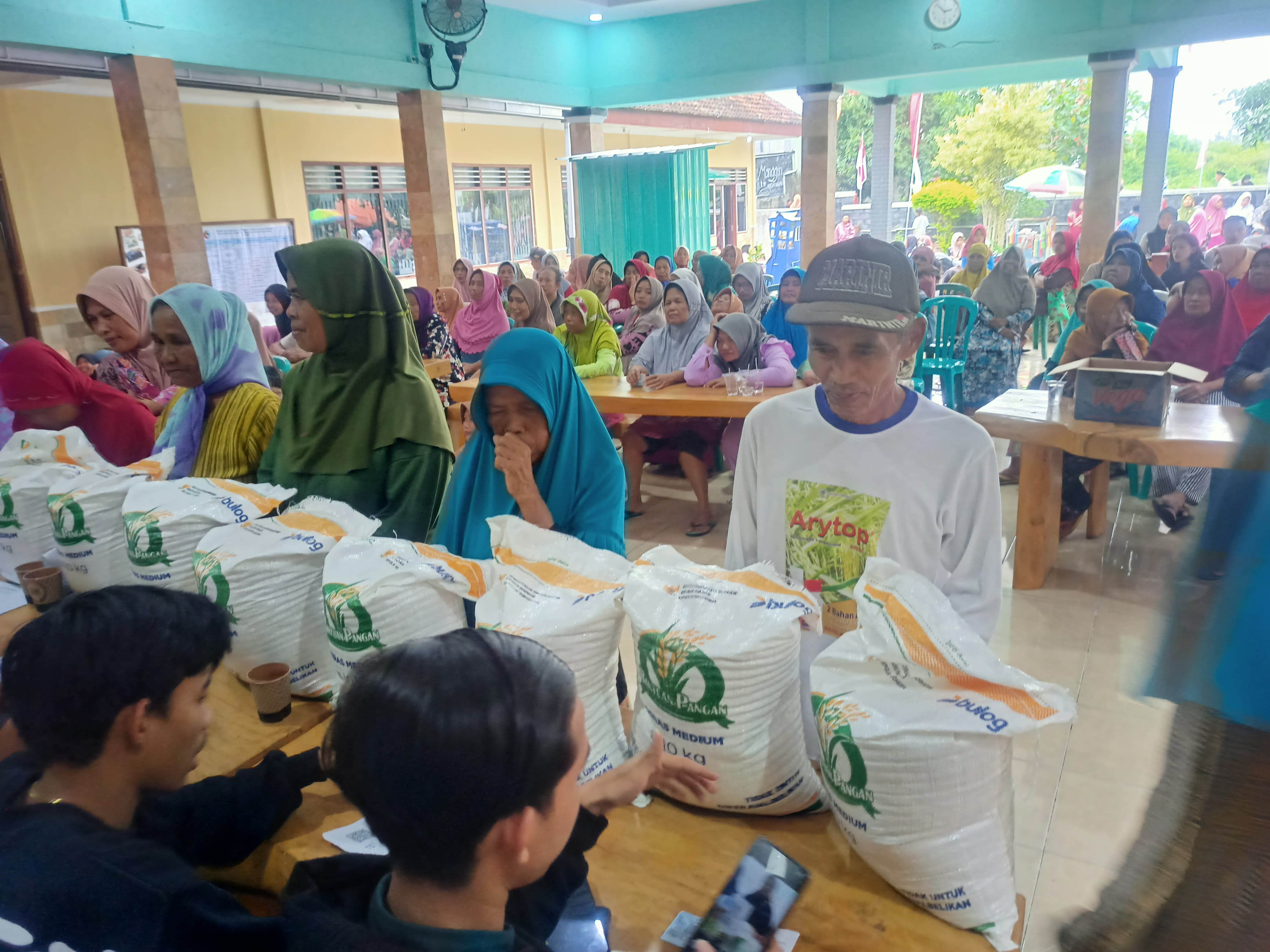 Proses penyerahan bantuan beras dengan menunjukan kartu identitas di Kantor Desa/Kecamatan Singojuruh.