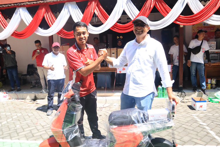 BERUNTUNG: Wakil Direktur RSUD Blambangan H Budi Priyambodo (kanan) saat memberikan hadiah jalan sehat pada Minggu (24/8).