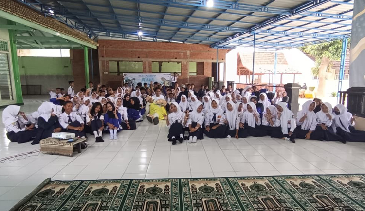 Seratus siswa SMPN 1 Glagah berfoto bersama relawan BSTF dan maskot penyu setelah menerima edukasi tentang konservasi Penyu, Selasa (26/8).