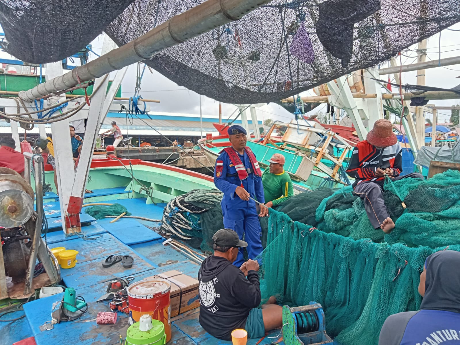 Kanit Polairud Muncar Bripka I Wayan Wedhana memberi wejangan ke nelayan supaya lebih waspada terhadap cuaca di Pelabuhan Muncar.