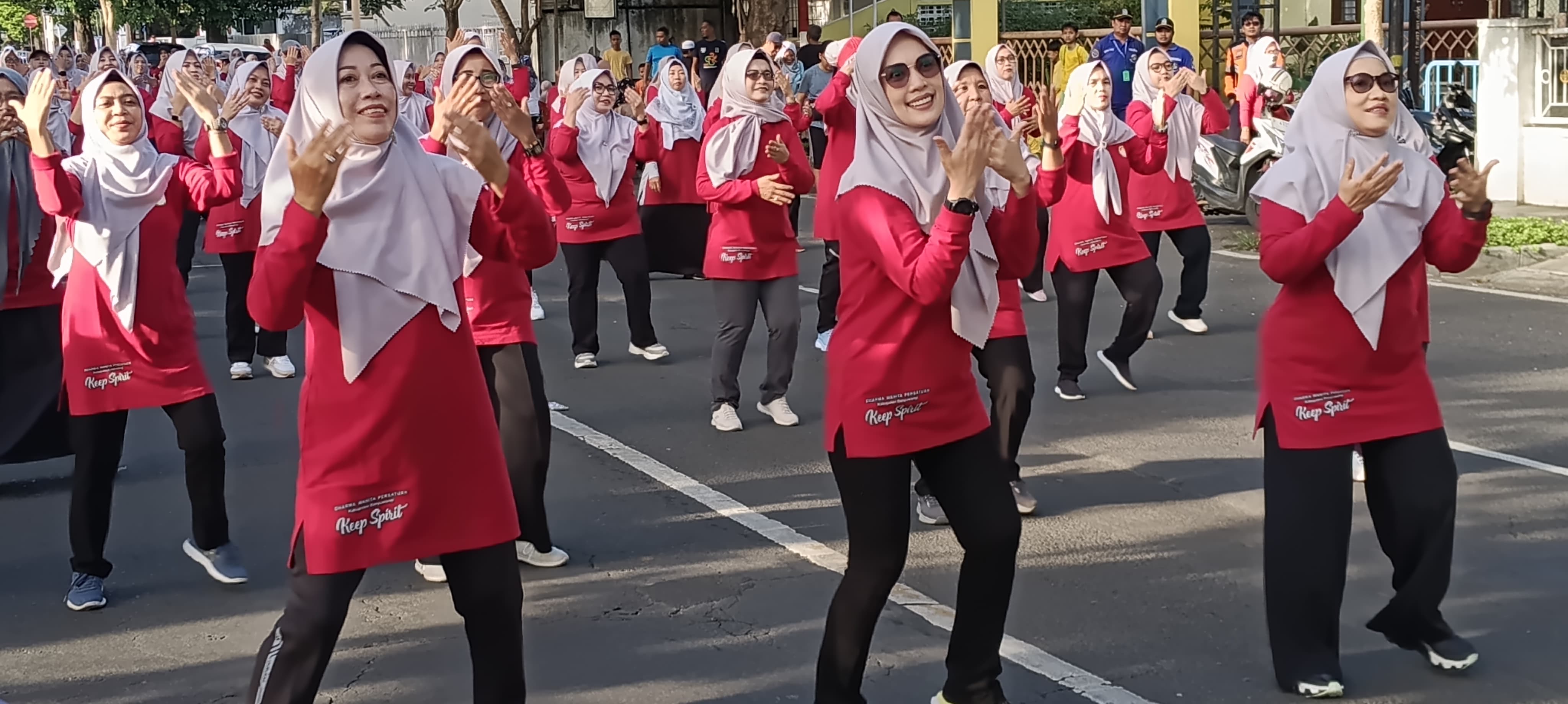 Ketua DWP Banyuwangi Linna Kurniawati (tengah) bersama jajaran pengurus dan anggota saat senam bersama di Car Free Day A Yani Banyuwangi, Minggu (16/11/2025).