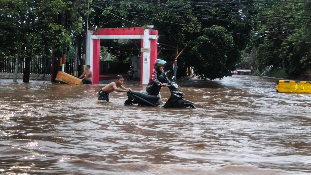 LUAPAN SUNGAI BAGONG: Kendaraan menerjang genangan air di depan Hotel Santika, tepatnya di sepanjang Jalan S Parman, Sobo, Banyuwangi, Senin sore (17/11).