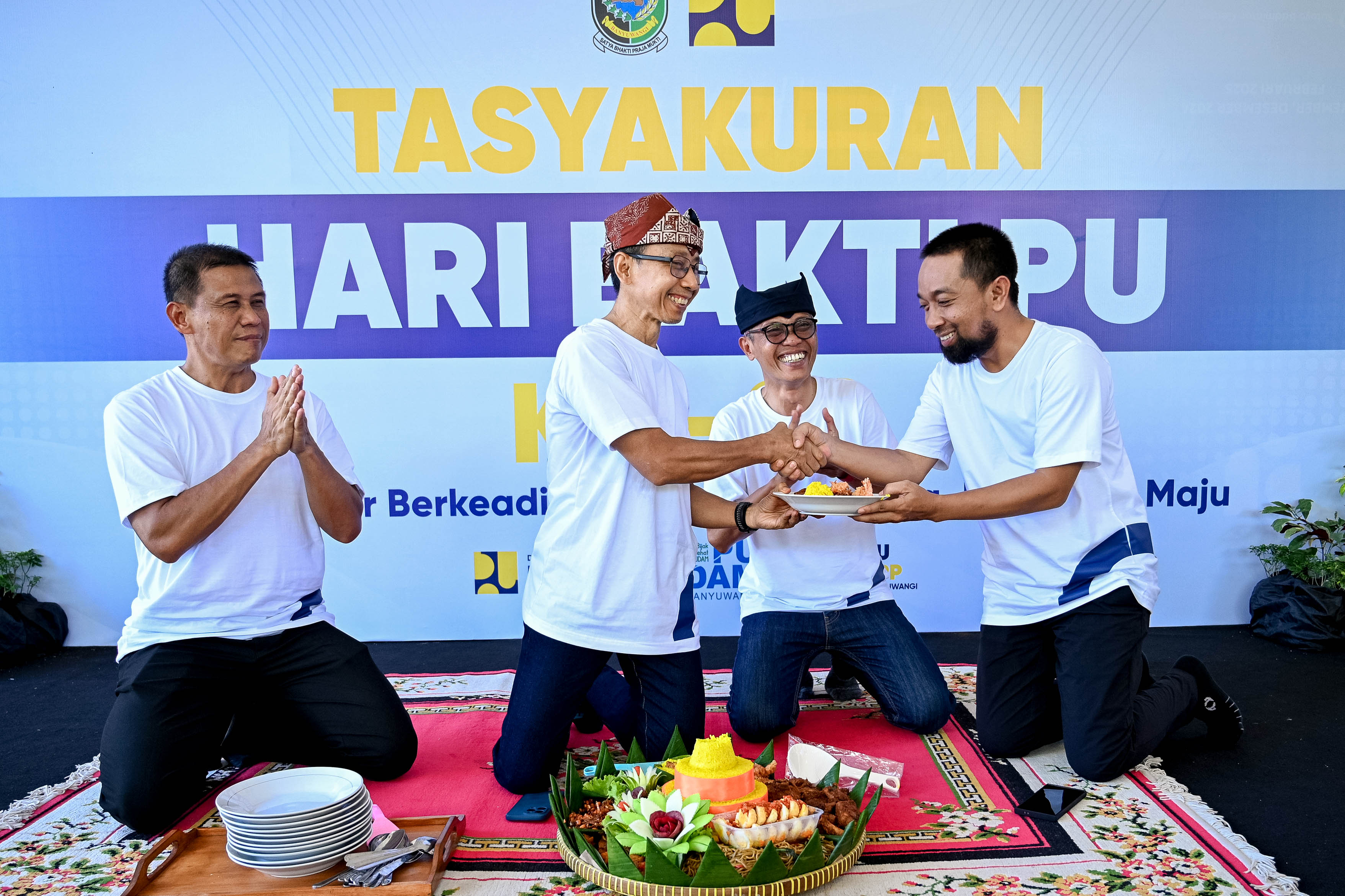 TASYAKURAN: Sekkab Guntur Priambodo memberikan potongan tumpeng kepada Plt Kepala Dinas PU Pengairan Riza Al Farohby pada acara tasyakuran Hari Bakti PU ke-80 Rabu (3/12).