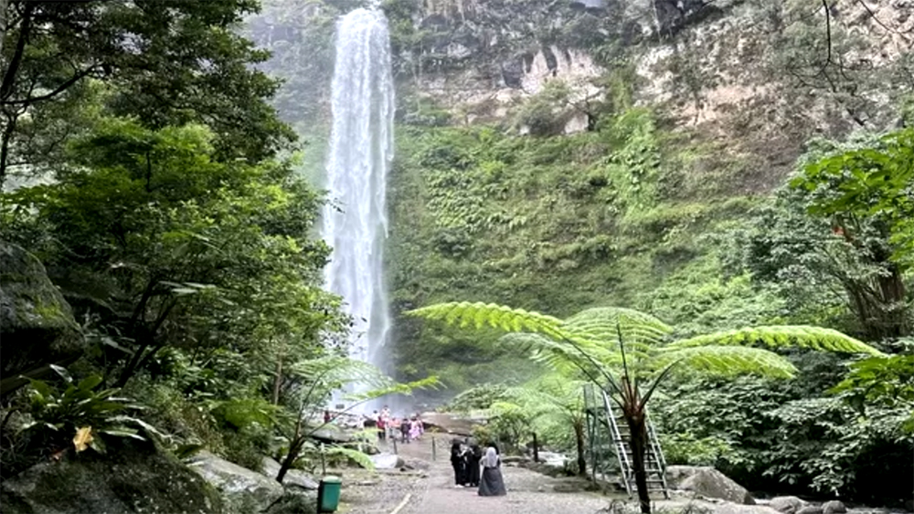 Air terjun Coban Rondo yang mengalir deras dari puncak ketinggian.