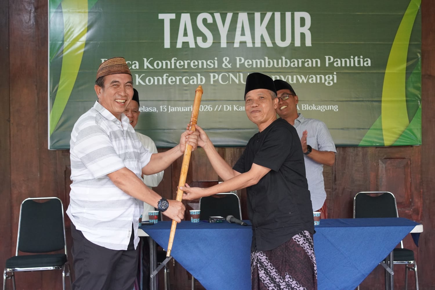 SUPAYA AMANAH: Karyono menyerahkan tongkat berbahan kayu gaharu kepada Ketua Tanfidziyah terpilih Achmad Turmudzi dalam acara pembubaran panitia di Kampus 2 UIMSYA Blokagung.