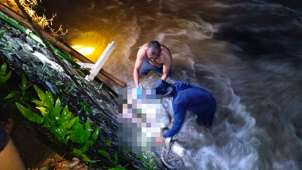 ANGKAT MAYAT: Petugas gabungan lakukan evakuasi jenazah pria lansia yang tersangkut di Sungai Gulung, Desa Kemiren, Kecamatan Glagah, Minggu (18/1).