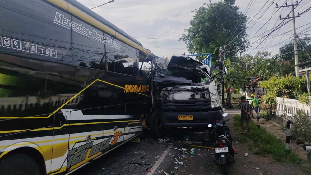 Truk nopol B 9347 UIP dan bus Pringgondani Putra nopol K 7005 C usai terlibat  kecelakaan di jalan raya Desa Sidodadi, Kecamatan Wongsorejo, Kamis pagi (19/2).